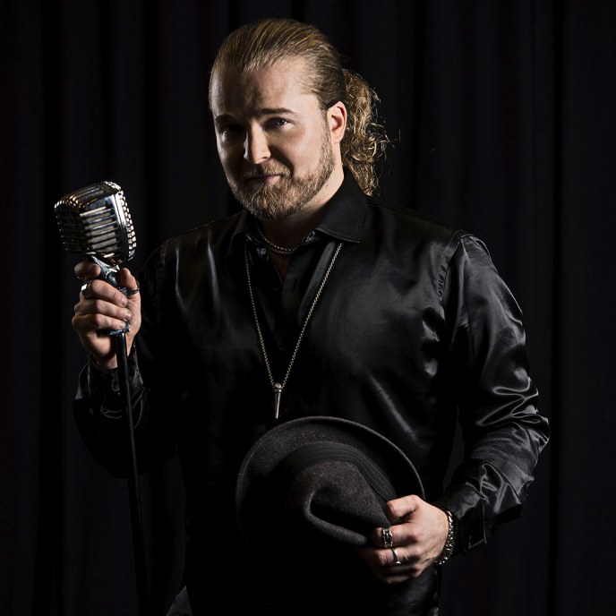 The singer Teemu Roivainen is holding a mic, the photo was taken by Pasi Liesimaa