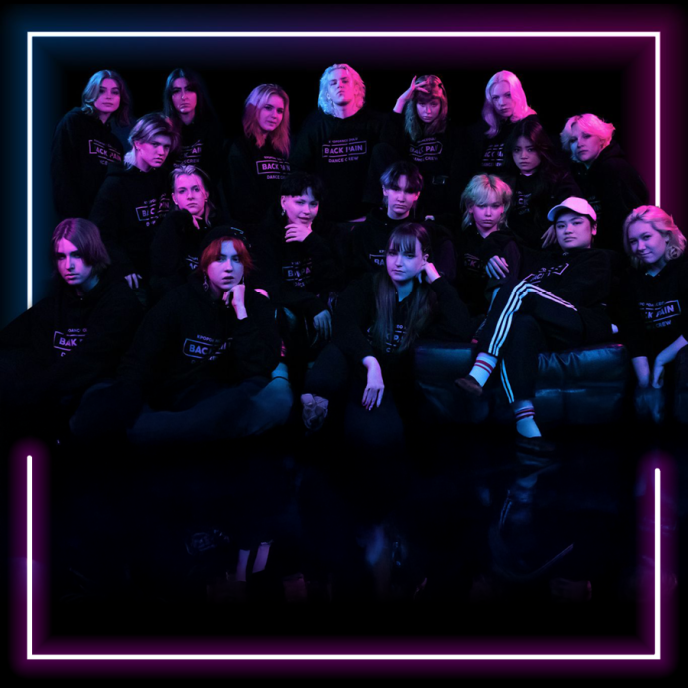 A group of people on a dark background with reddish lighting